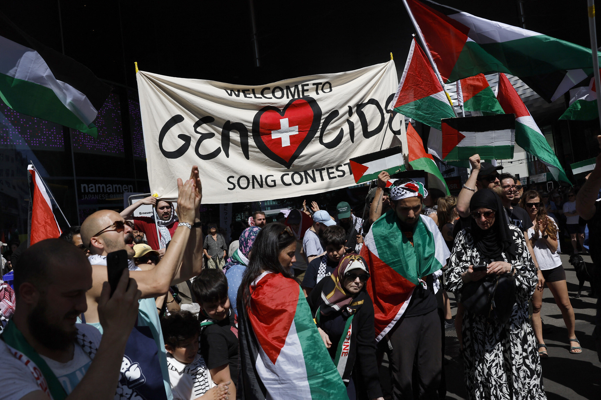 A group of protesters waving Palestine flags at Eurovision highlighting the Israeli genocide of Palestinians
